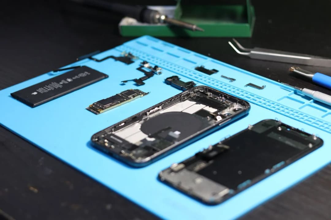 A technician repairing a device at NZ Tech Repairs